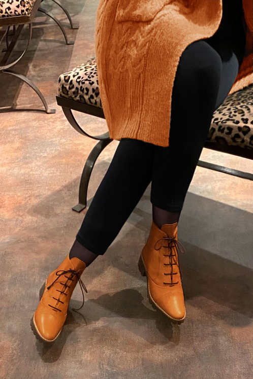 Marigold orange women's ankle boots with laces at the front. Round toe. Low rubber soles. Worn view - Florence KOOIJMAN